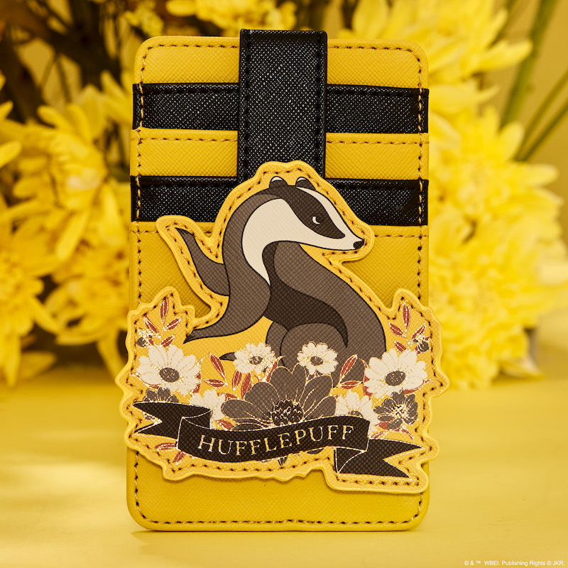 Black and yellow Hufflepuff card holder featuring an appliqué in the center of the Hufflepuff badger, sitting against a yellow background with a real bouquet of yellow flowers  